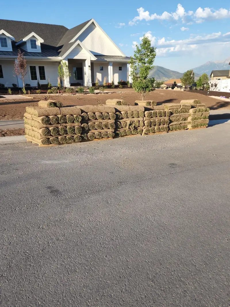 Stacked rolls of sod delivered to a job site in front of a Utah home